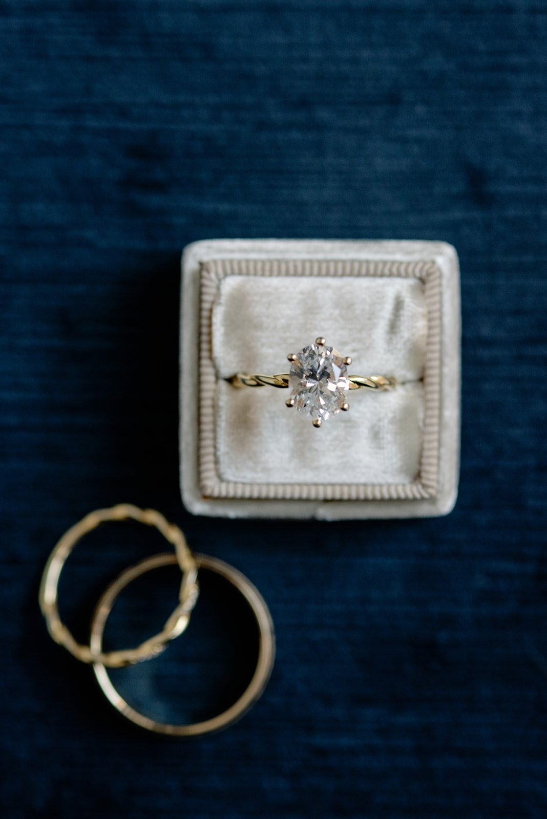  Gold oval diamond engagement ring from Touch of Gold Halifax in velvet ring box on navy blue background 