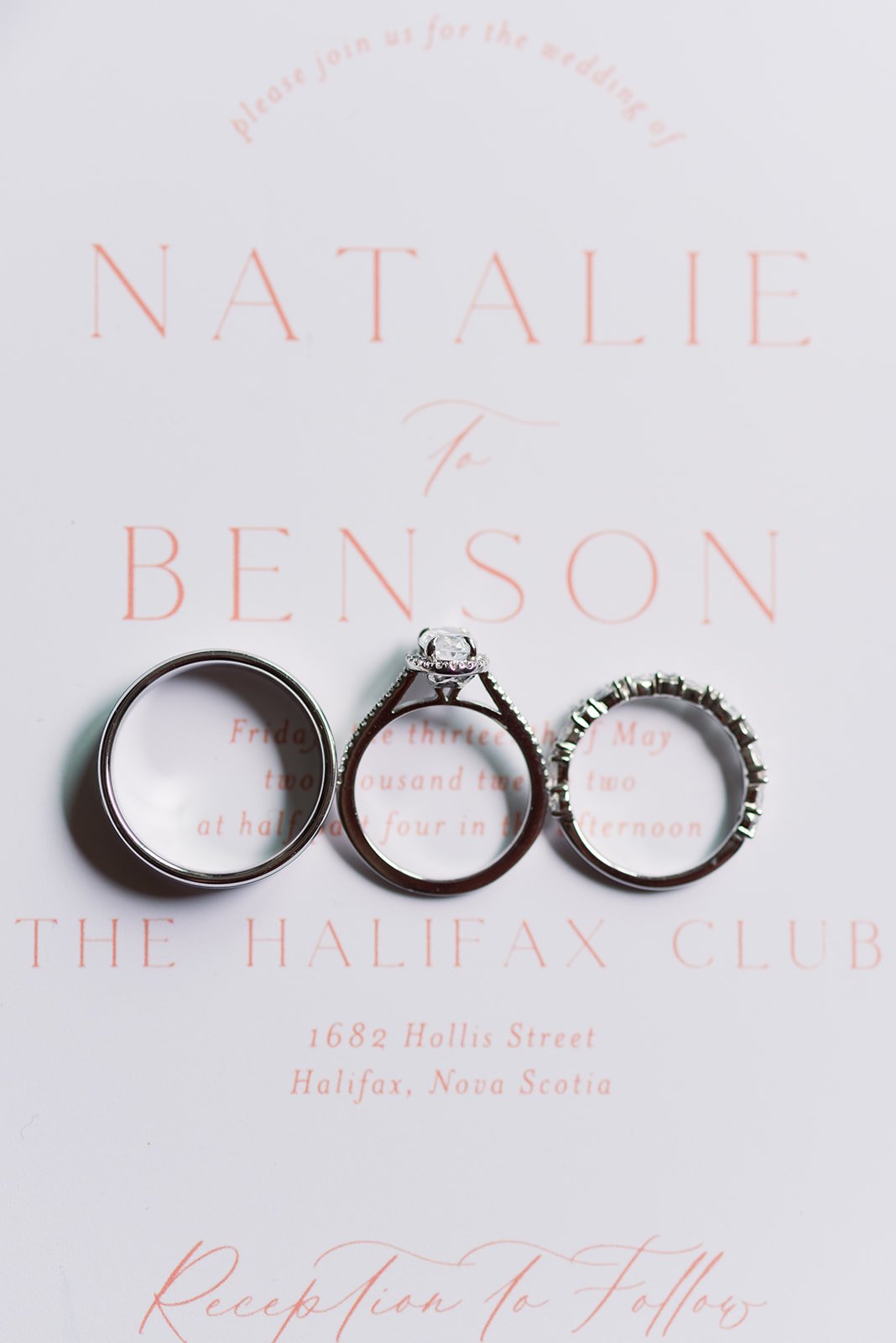  Three silver wedding rings from Touch of Gold Halifax on top of Lupin Design Studio wedding invitation 