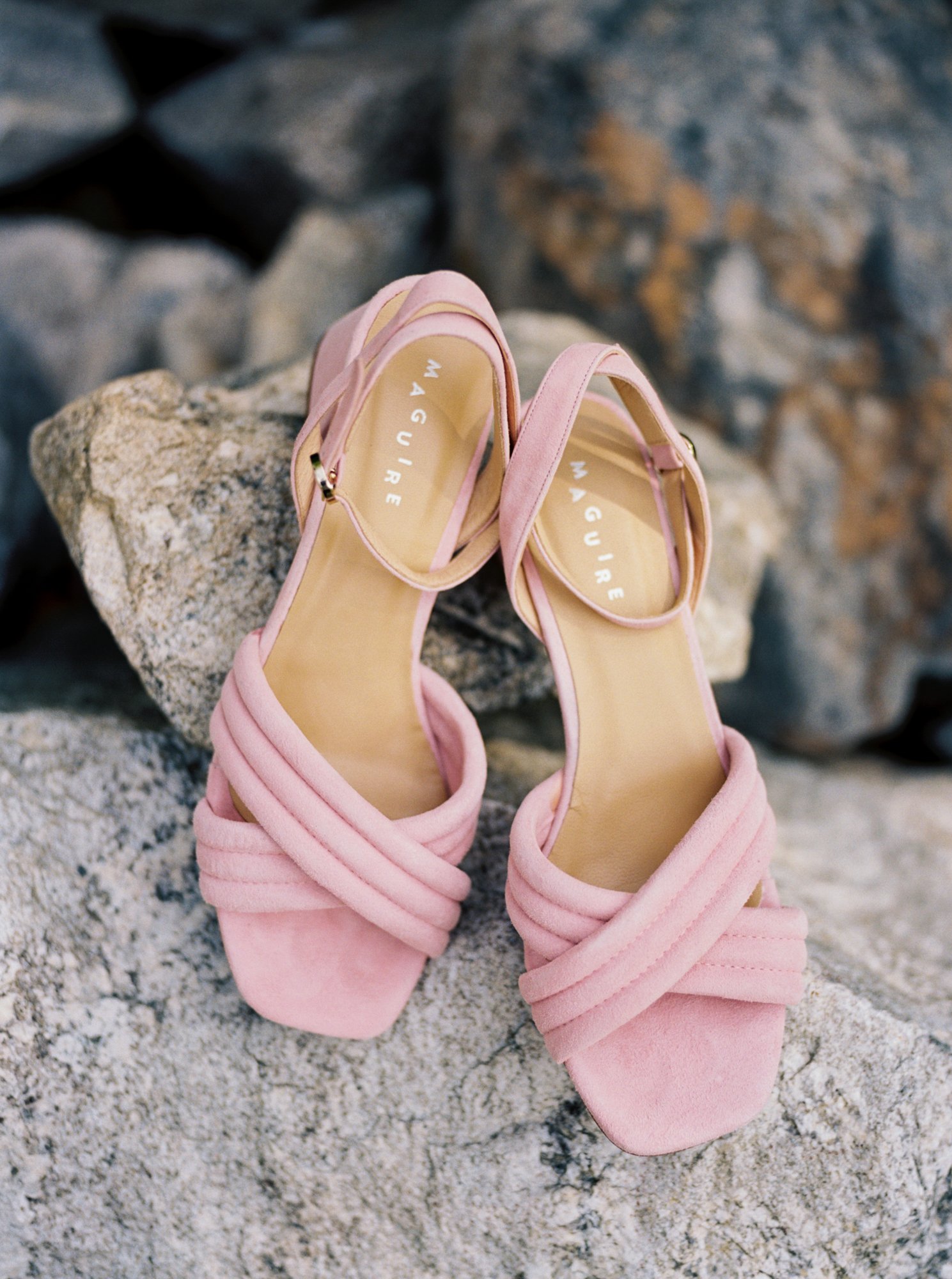  Pink wedding shoes on stone background 