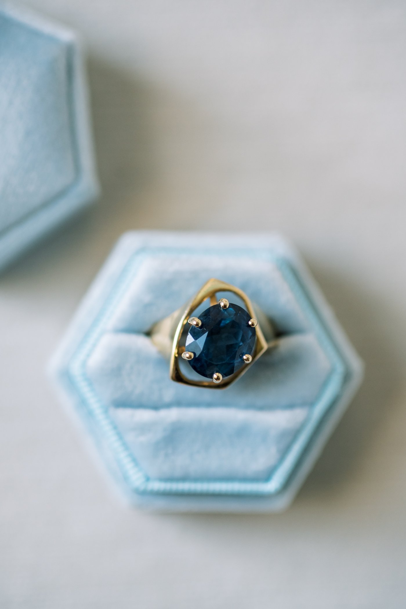 Blue topaz and yellow gold ring in a powder blue ring box