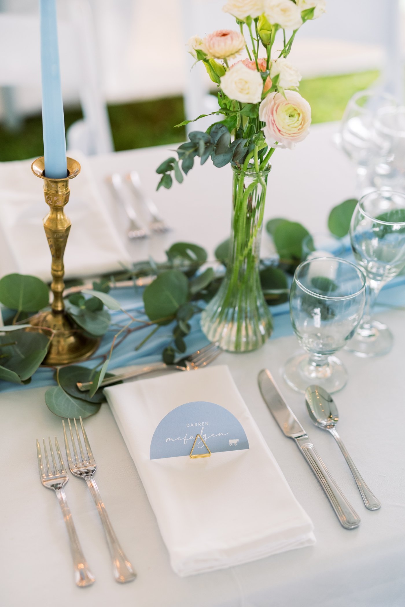 Coastal wedding table setting with powder blue place card and white linens