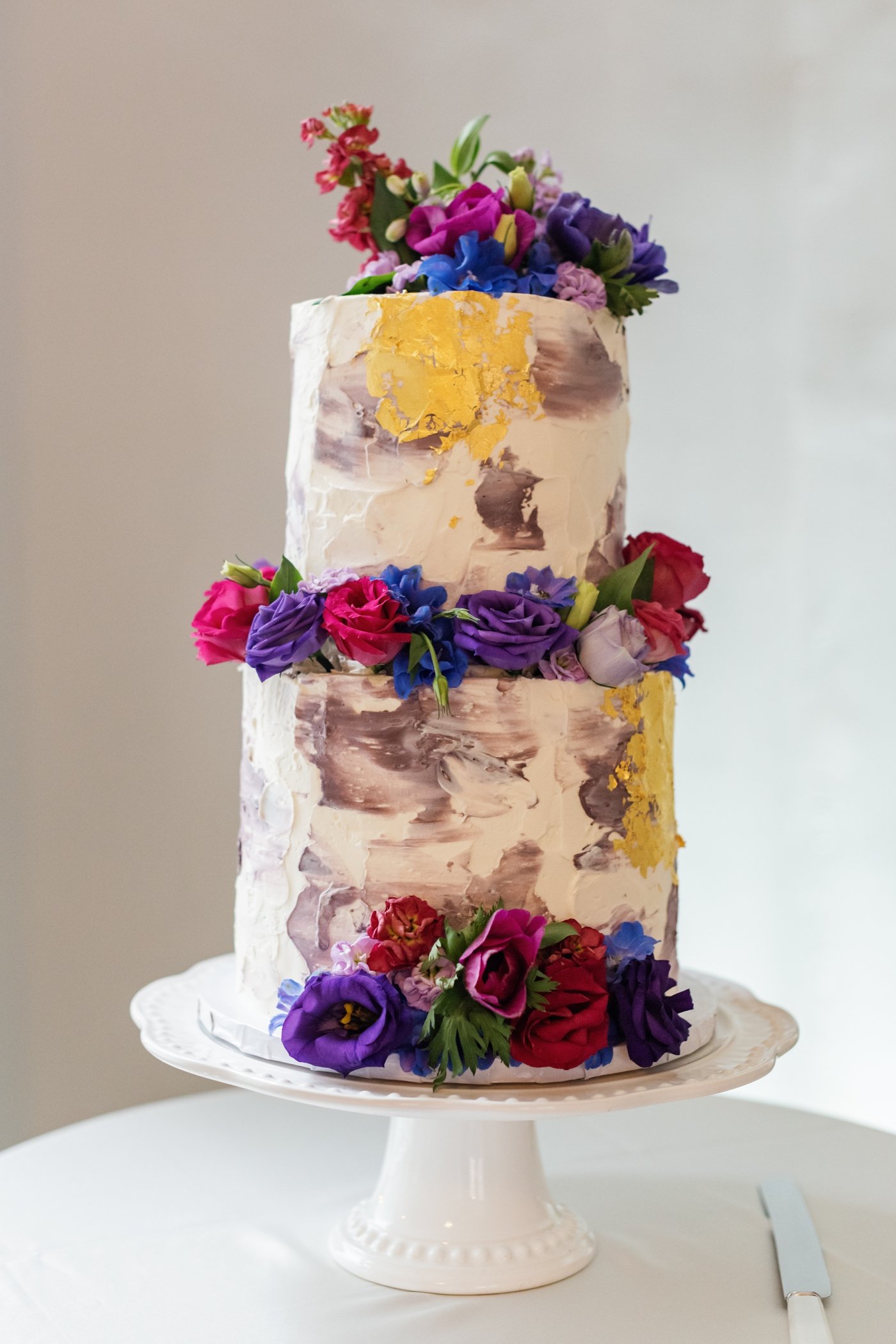 Purple and yellow painted buttercream wedding cake