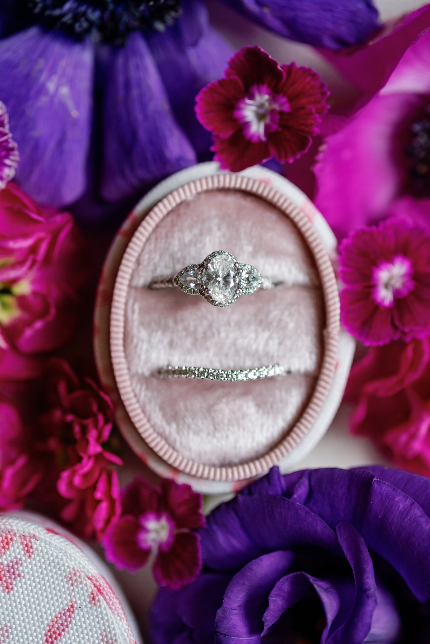 Three stone diamond engagement ring in a pink velvet ring box