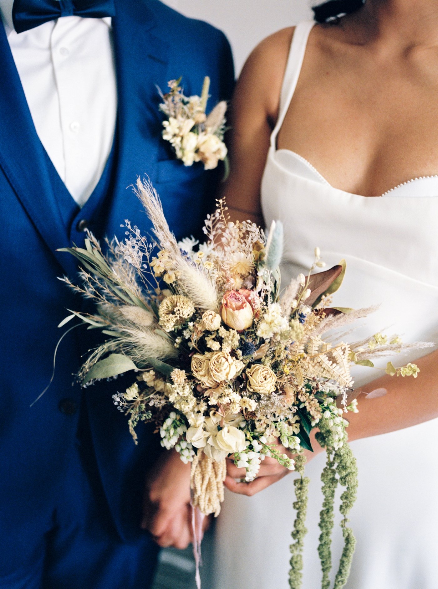 Bridal bouquet filled with dried roses and pampas grass